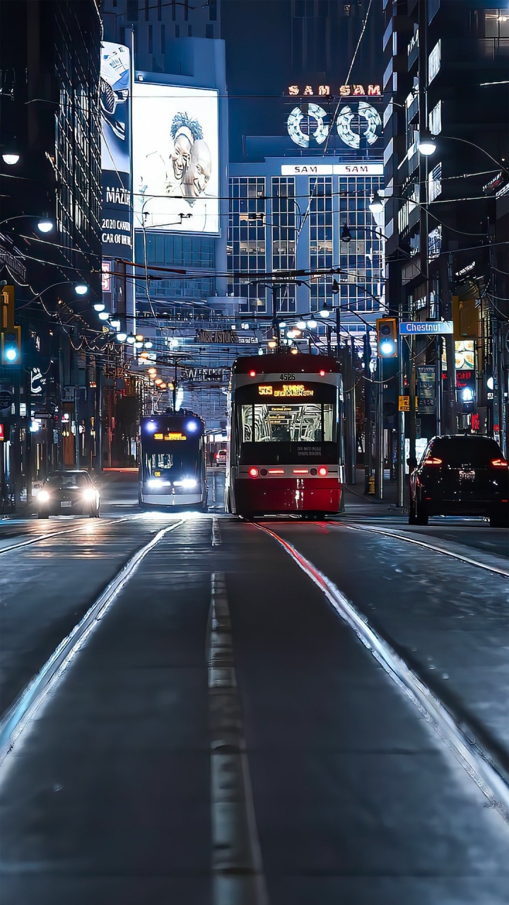 Обои здание, автобус, легковые автомобили, автомобильное освещение, свет в разрешении 720x1280